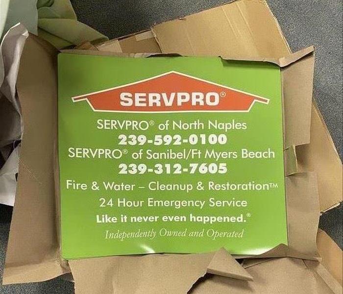 Large green SERVPRO magnets in a box. 
