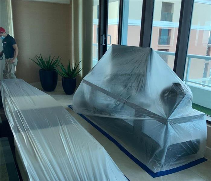 Plastic sheets protecting furniture.