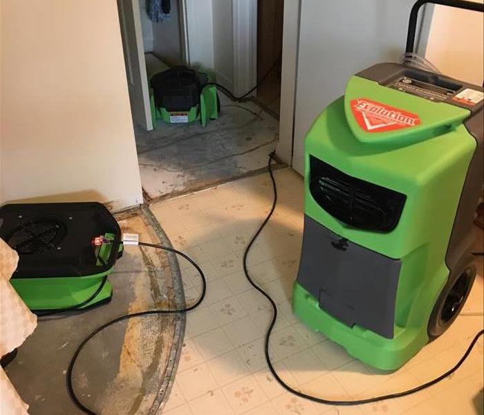 Air movers and dehumidifier up and running in a home.